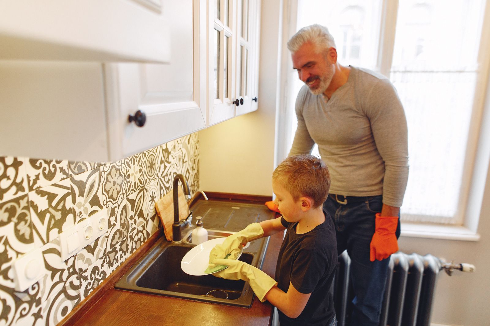 Parent and child doing the dishes together